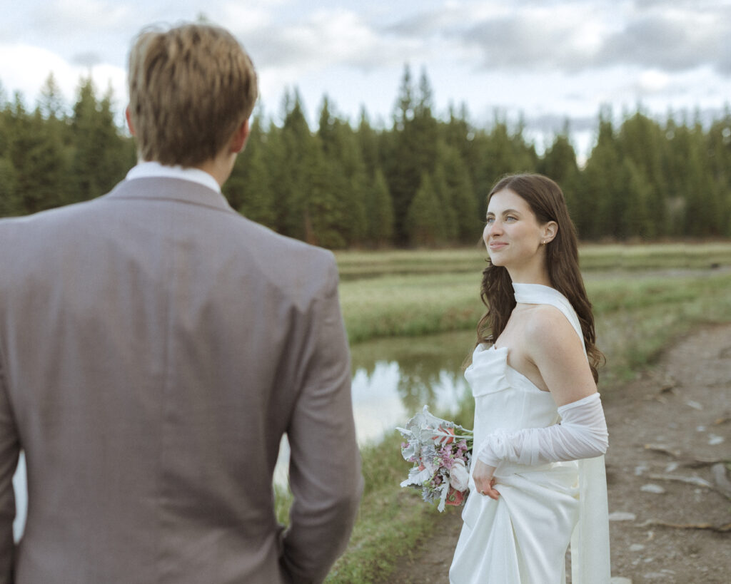 couple taking their wedding photos at their Schwabacher Landing Elopement