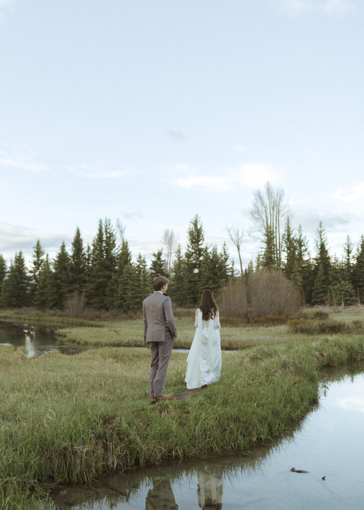 couple taking their wedding photos at their Schwabacher Landing Elopement