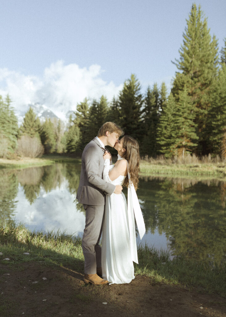 couple taking their wedding photos at their Schwabacher Landing Elopement