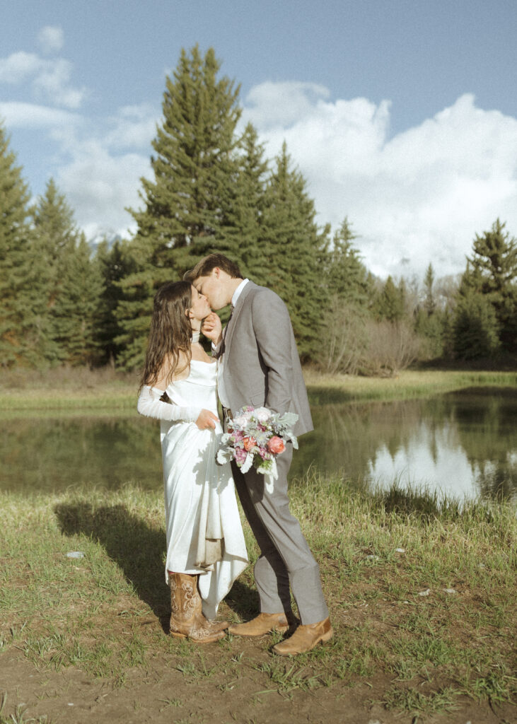 couple taking their wedding photos at their Schwabacher Landing Elopement