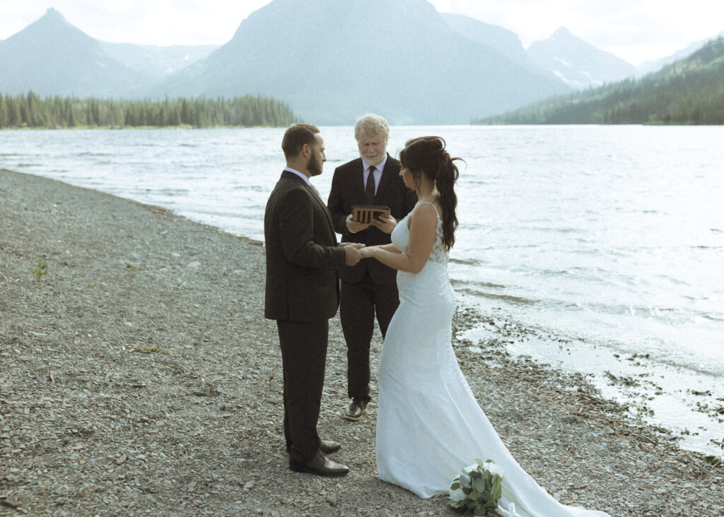 couple reading their vows for their Two Medicine Lake Elopement 