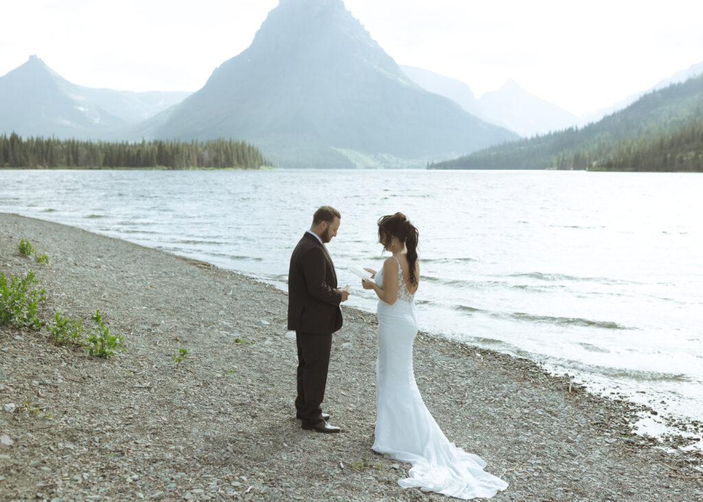 couple reading their vows for their Two Medicine Lake Elopement 