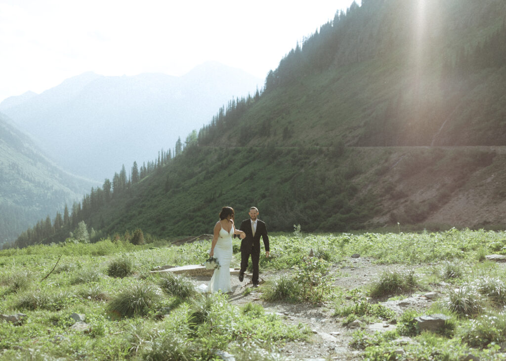 couple exploring Glacier National Park after their Two Medicine Lake Elopement 