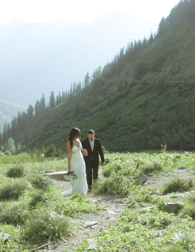couple exploring Glacier National Park after their Two Medicine Lake Elopement 