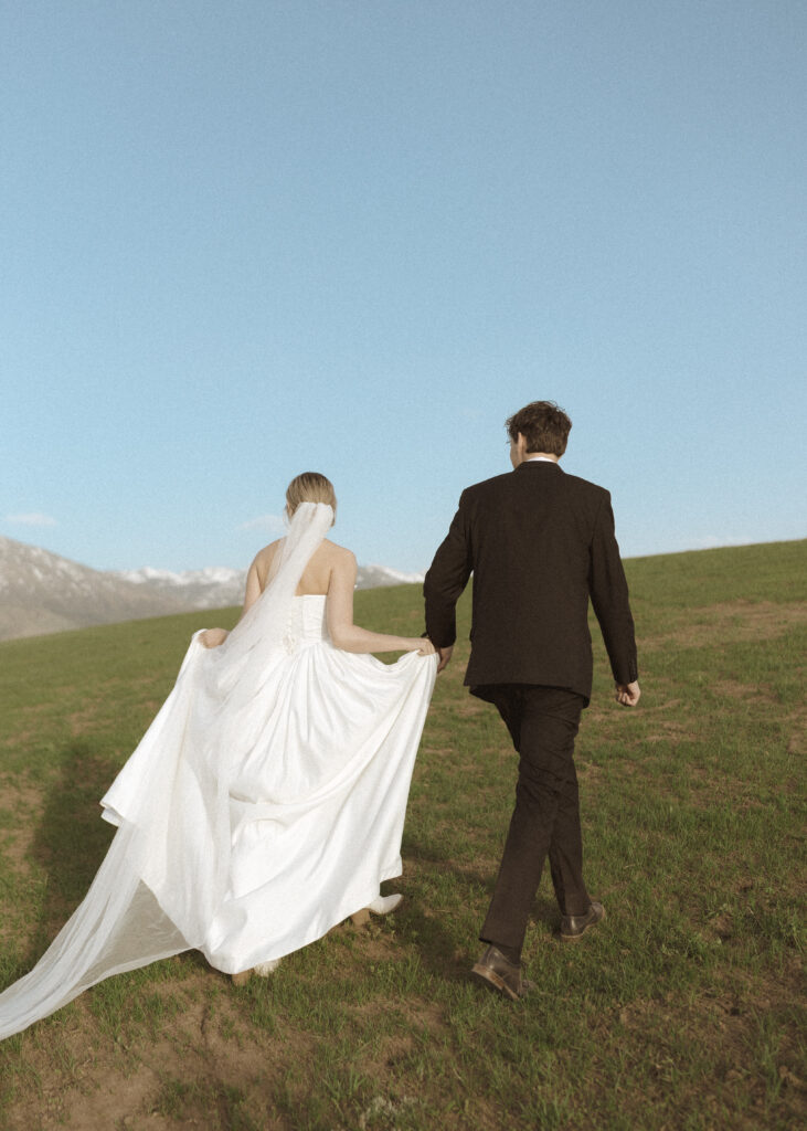 couple taking wedding photos for their Wyoming Horse Elopement 