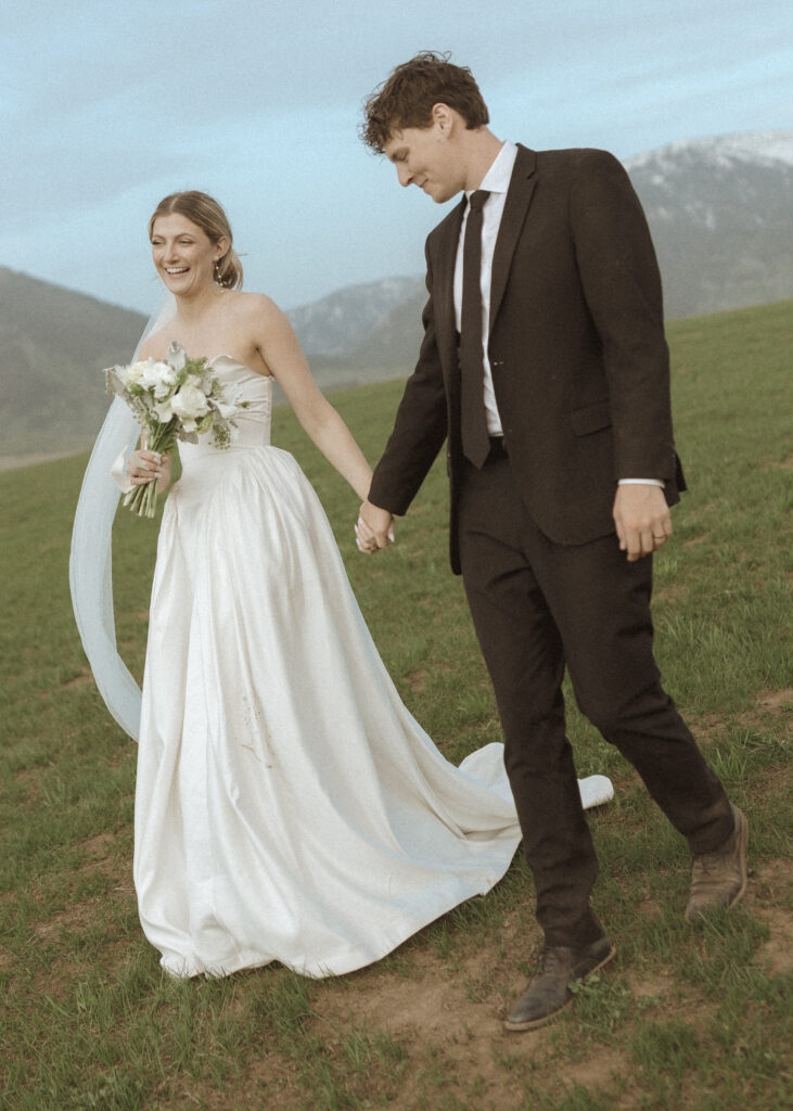 couple taking wedding photos for their Wyoming Horse Elopement 