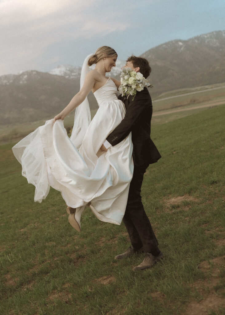 couple taking wedding photos for their Wyoming Horse Elopement 
