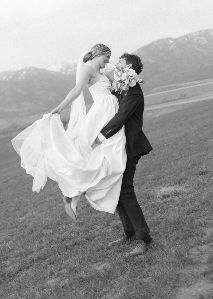 couple taking wedding photos for their Wyoming Horse Elopement 