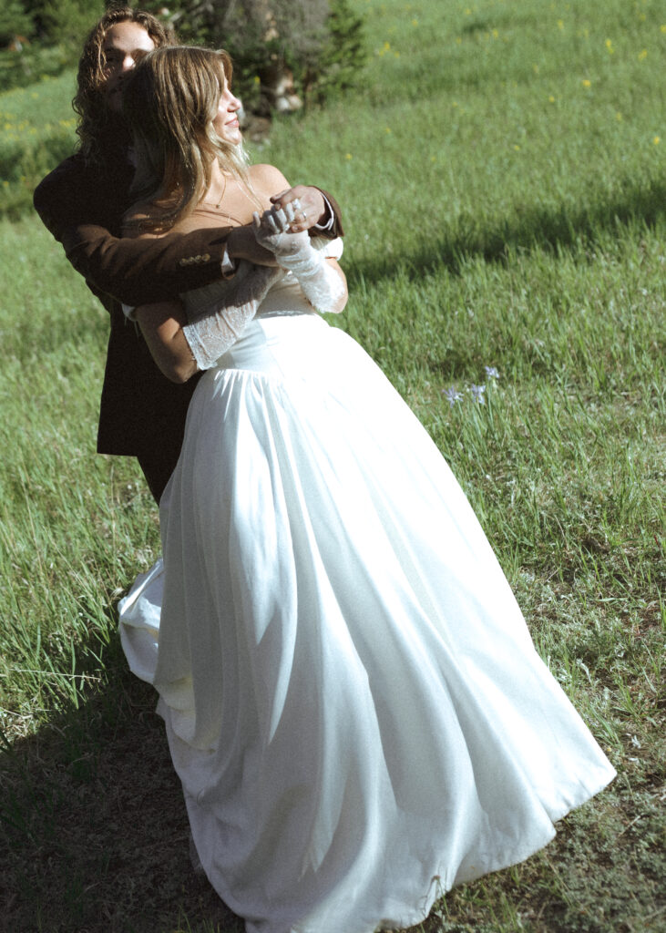 bride and groom taking photos for their rmnp elopement 