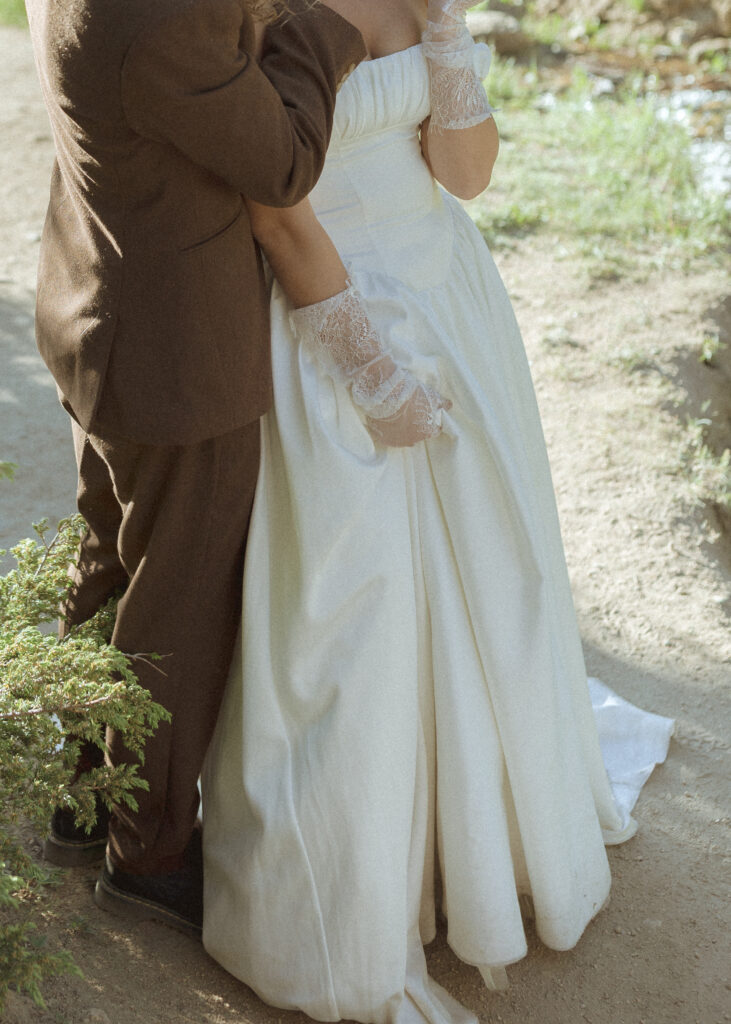 bride and groom taking photos for their rmnp elopement 