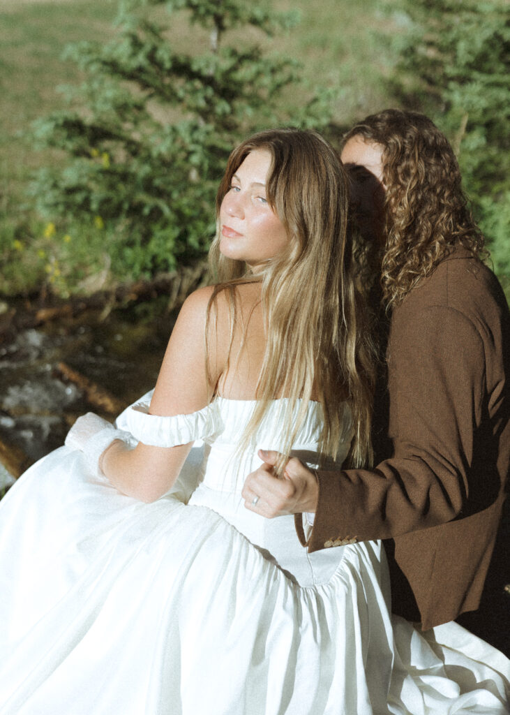 bride and groom taking photos for their rmnp elopement 