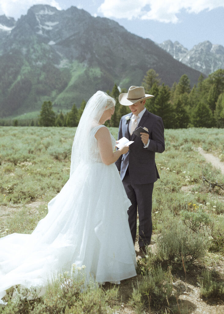 Bride and Groom Reading Vows in Grand Teton National Park 