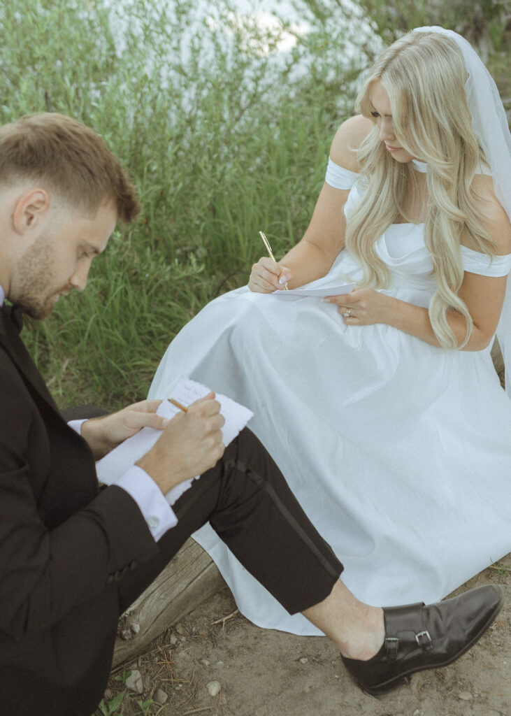 bride and groom writing vows in the tetons 