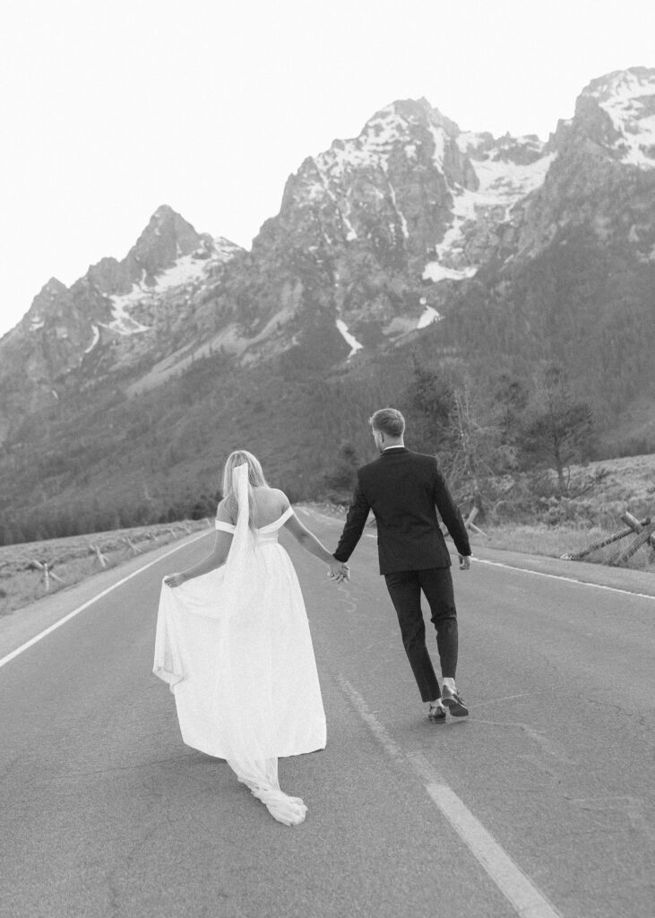 bride and groom taking wedding photos in the tetons 