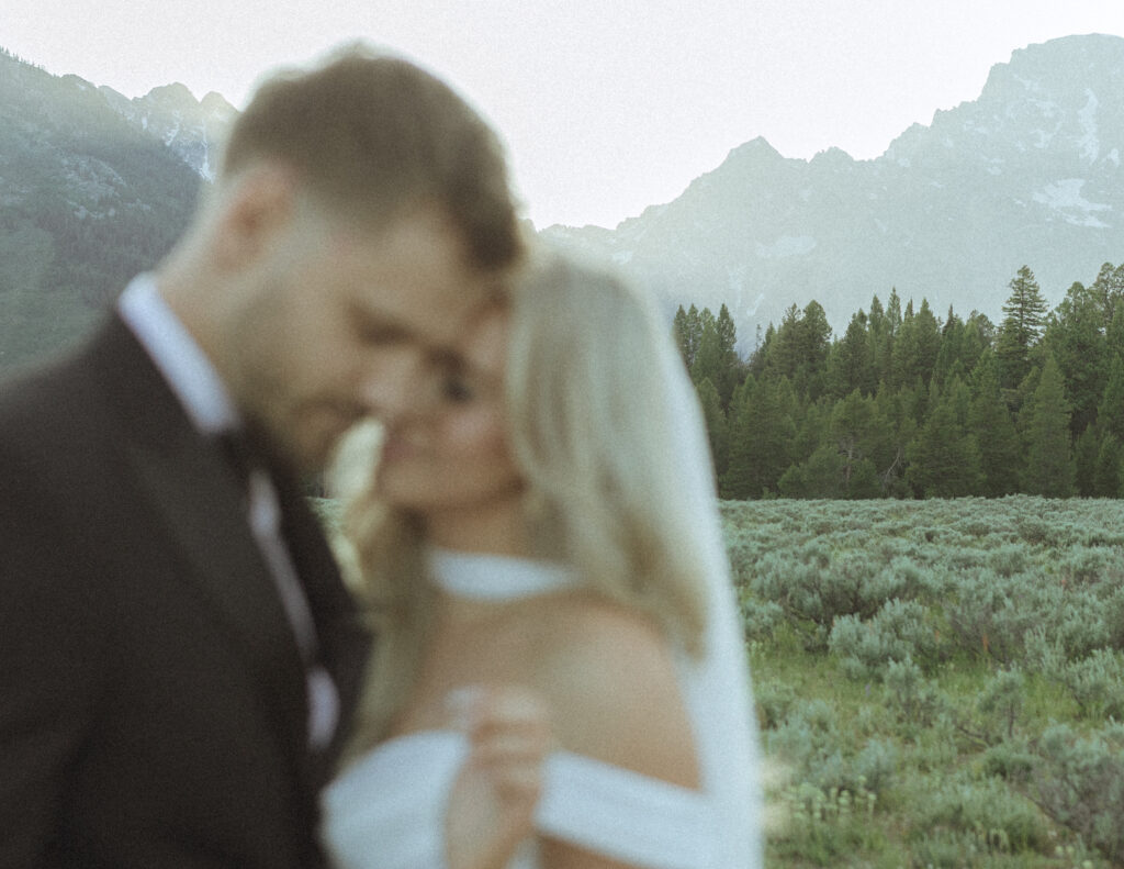 bride and groom taking wedding photos in the tetons 