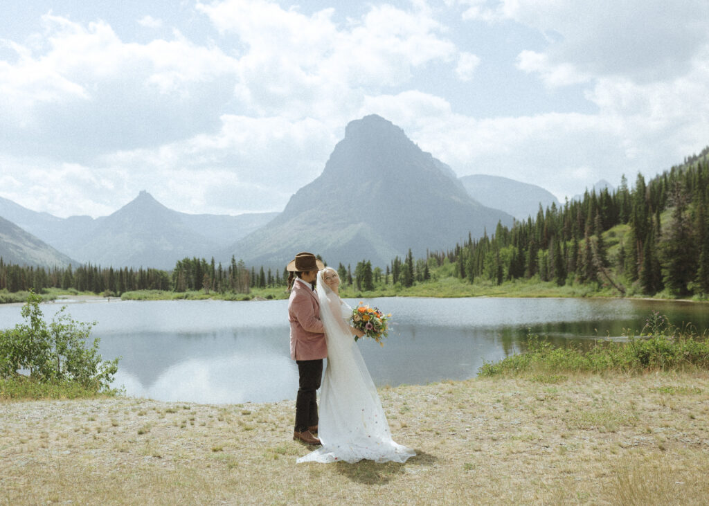 bride and groom taking wedding photos in Glacier National Park 