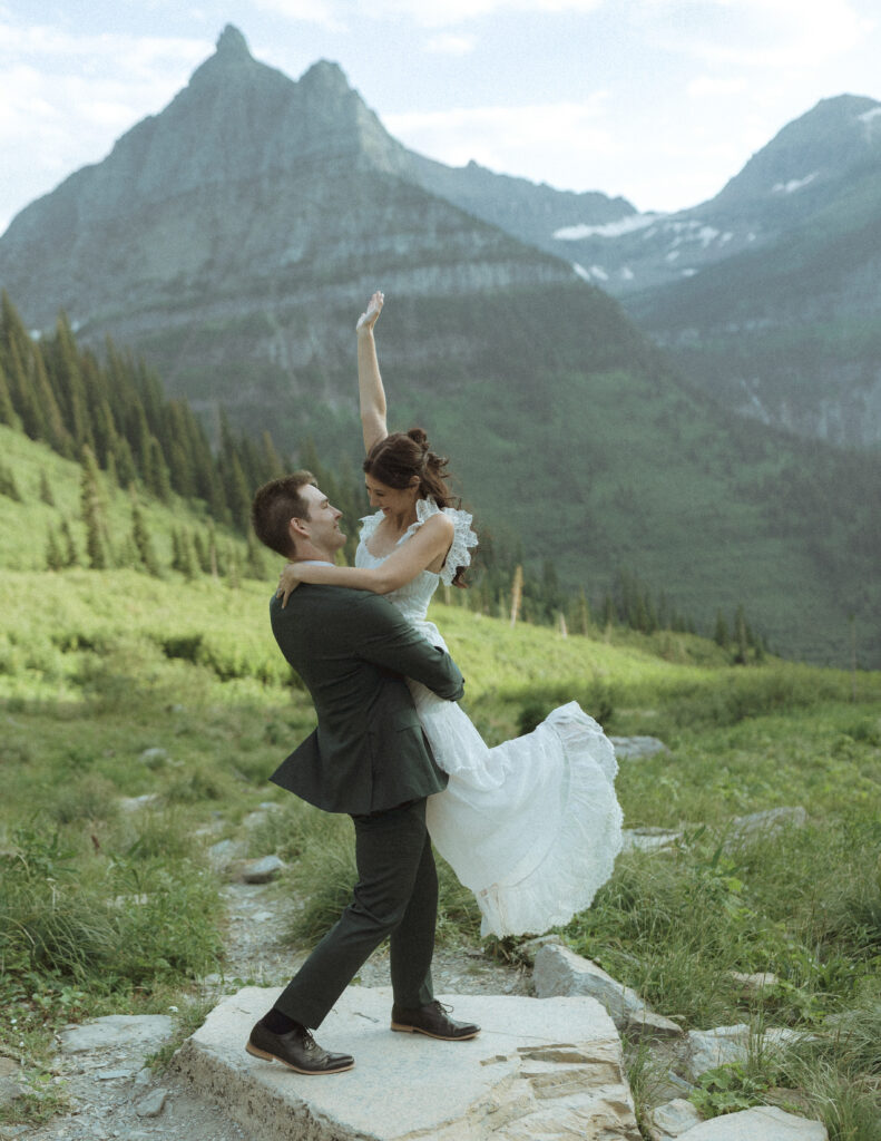 bride and groom taking wedding photos on going to the sun road 